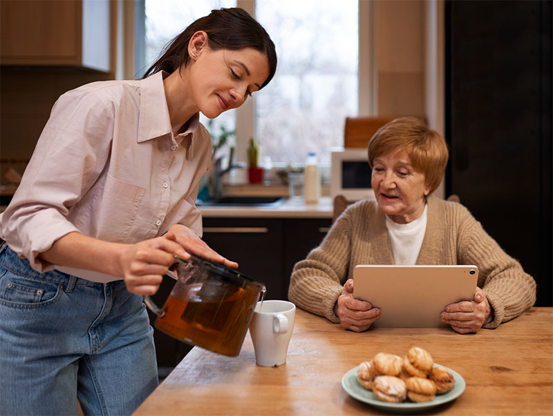 Carer speaking with family at a table