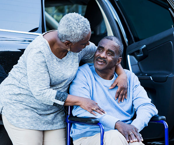 Carer answering questions from an older person and their family at home